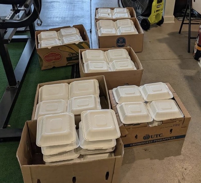 Boxes packed with compostable takeout containers ready for a meal share